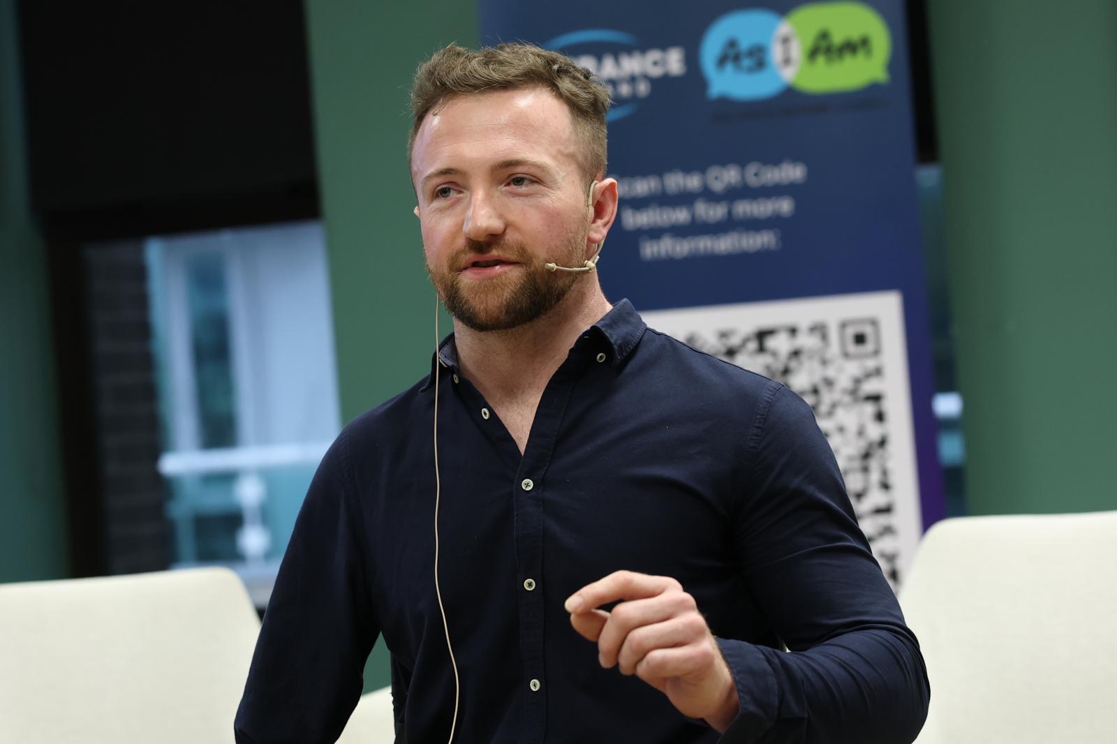 Colin Judge mid-talk wearing a headset microphone