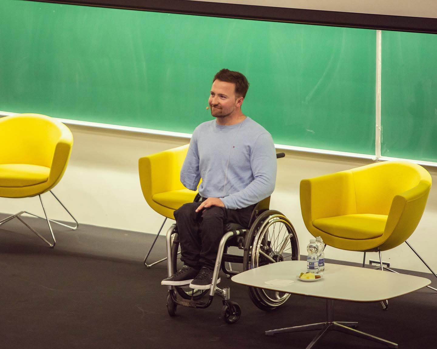 Colin Judge on stage during a fireside-style talk